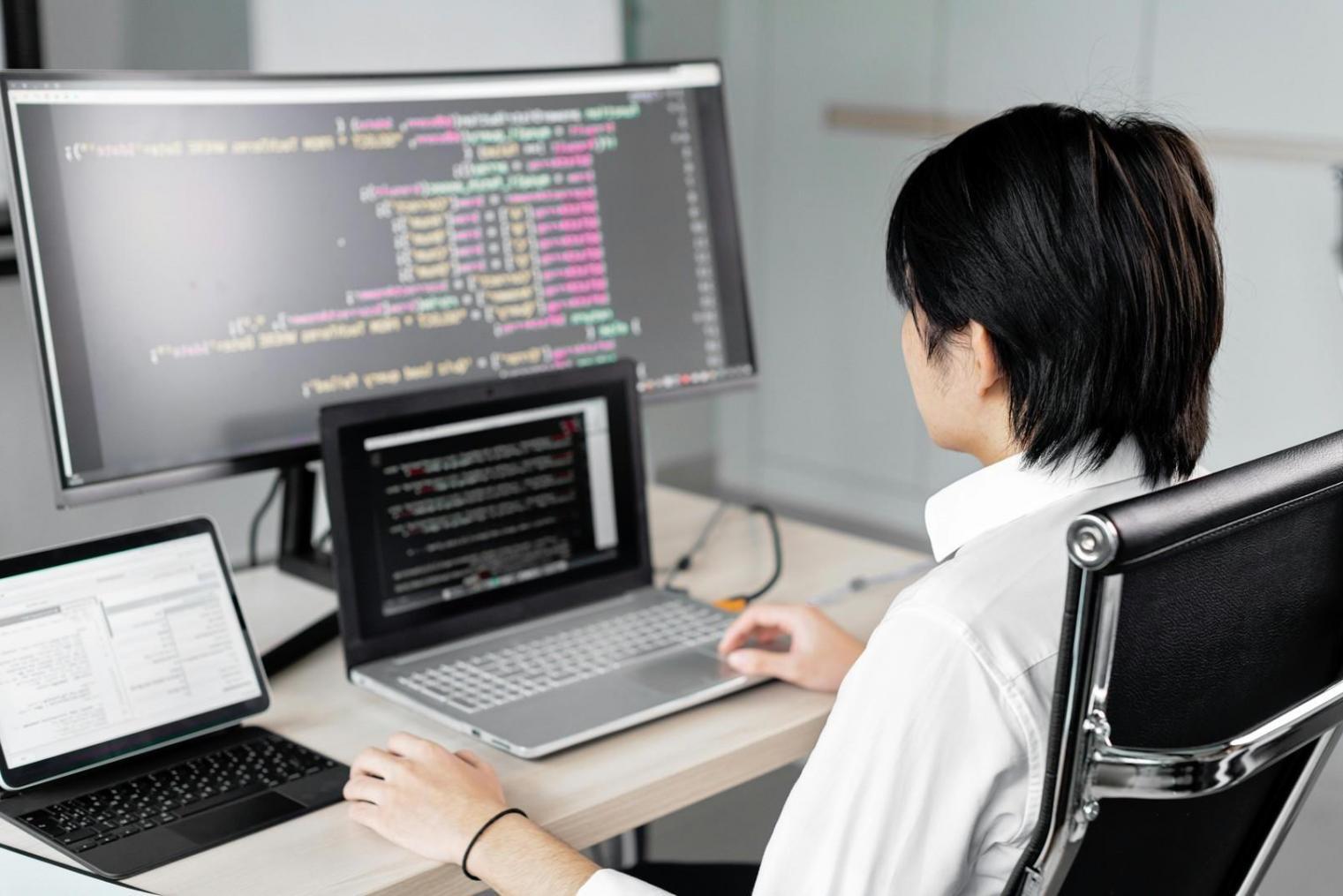 Testing environment with multiple monitors displaying code coverage metrics and test execution dashboards
